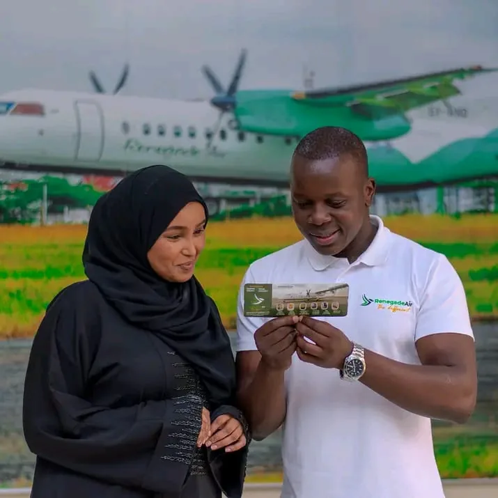 Renegade Air agent handing a printed ticket to a traveller